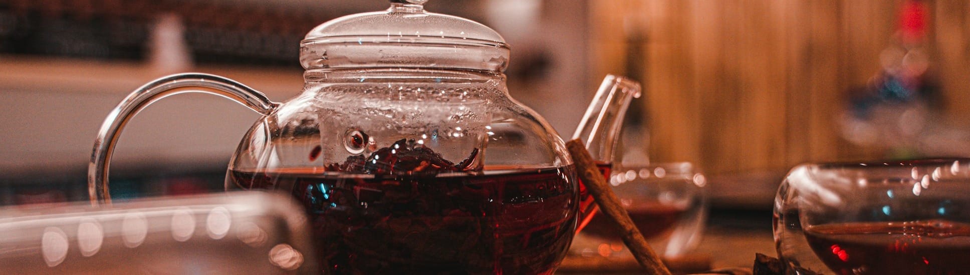 clear glass teapot on brown wooden table